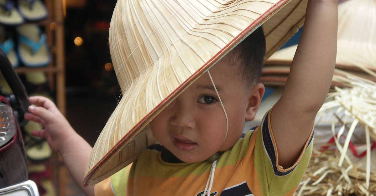 A young boy in Vietnam with a hat.