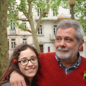 A man puts his arm around his daughter's shoulder in Portugal.