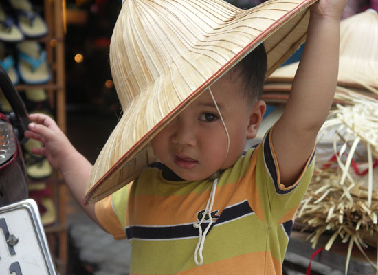A young boy in Vietnam with a hat.